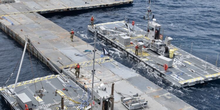 This handout picture courtesy of the US Central Command (CENTCOM) taken on April 26, 2024 shows construction work on the floating Joint Logistics Over-The-Shore (JLOTS) pier in the Mediterranean Sea, which will support the US Agency for International Development (USAID) and partners to receive and deliver humanitarian aid to the Gaza Strip. (Photo by US Central Command (CENTCOM) / AFP) / RESTRICTED TO EDITORIAL USE - MANDATORY CREDIT "AFP PHOTO / US CENTRAL COMMAND (CENTCOM) - NO MARKETING NO ADVERTISING CAMPAIGNS - DISTRIBUTED AS A SERVICE TO CLIENTS